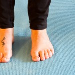 Woman's feet on yoga mat