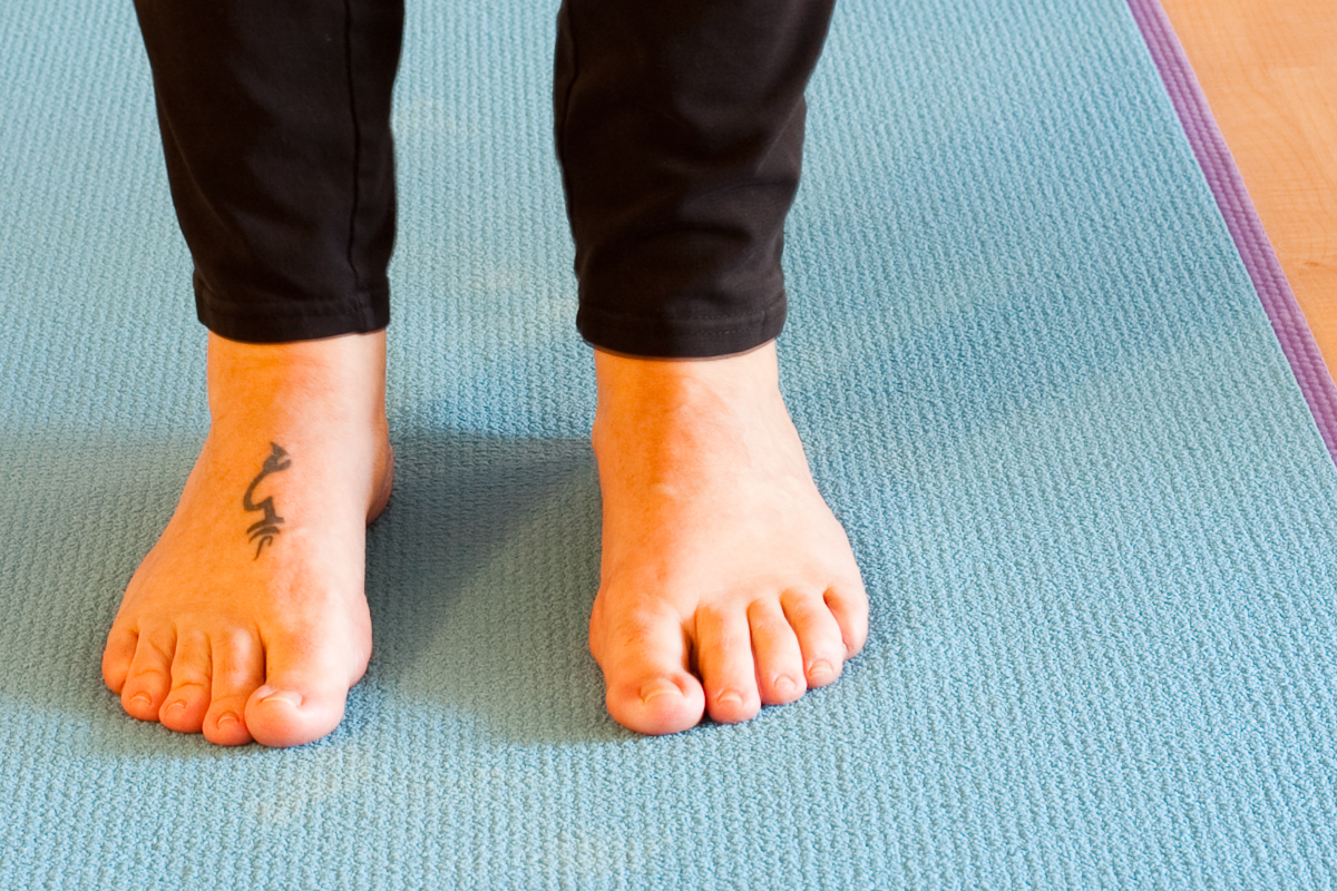 Woman's feet on yoga mat